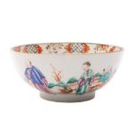 A Chinese famille rose bowl the exterior painted with figures in a fenced garden,
