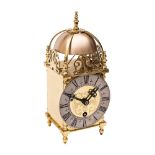 A small reproduction brass lantern clock,