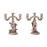 A pair of Meissen-style allegorical figural candlebra the branches applied with flowers and foliage,