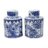 A large pair of Chinese blue and white tea jars and covers of cylindrical form,