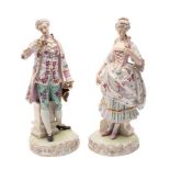 A pair of Continental figures of a gallant and lady wearing eighteenth century costume and each