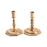 An 18th century brass candlestick with plain cylindrical sconce on a knopped and tapering stem