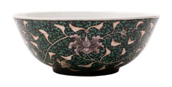 A black ground lotus bowl painted with lotus and green scrolling foliage on a black ground, 22cm.