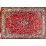 A Sarouk Carpet, the rose field with a central indigo shaped lozenge pole medallion,