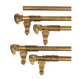 Four gilt metal curtain poles in Empire style, 20th century; comprising a pair,