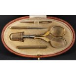 An early 20th century Asprey sewing companion, comprising a needle case, stamped '9CT', a thimble,