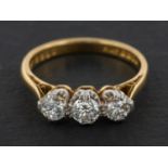 An 18ct gold, round, brilliant-cut diamond, three-stone ring, total estimated diamond weight ca. 0.