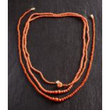 Two graduated coral bead necklaces, including one with a carved coral rose clasp,