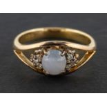 A cabochon-cut, oval, grey star sapphire and round, brilliant-cut diamond ring,