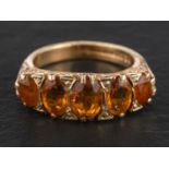 A 9ct gold, mixed-cut oval citrine five-stone ring, total estimated citrine weight ca. 2.