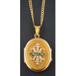 An emerald and seed pearl oval, locket pendant, with fleur-de-lys design to front,
