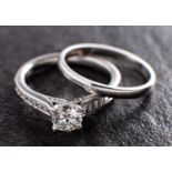 A platinum, round, brilliant-cut diamond ring and platinum band ring,