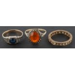 Three vari-coloured paste rings, the blue paste ring stamped '9CT' and 'SIL' ring sizes O & Q,