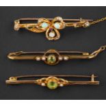 Three brooches, including two openwork, peridot and seed pearl bar brooches, one stamped '9CT',