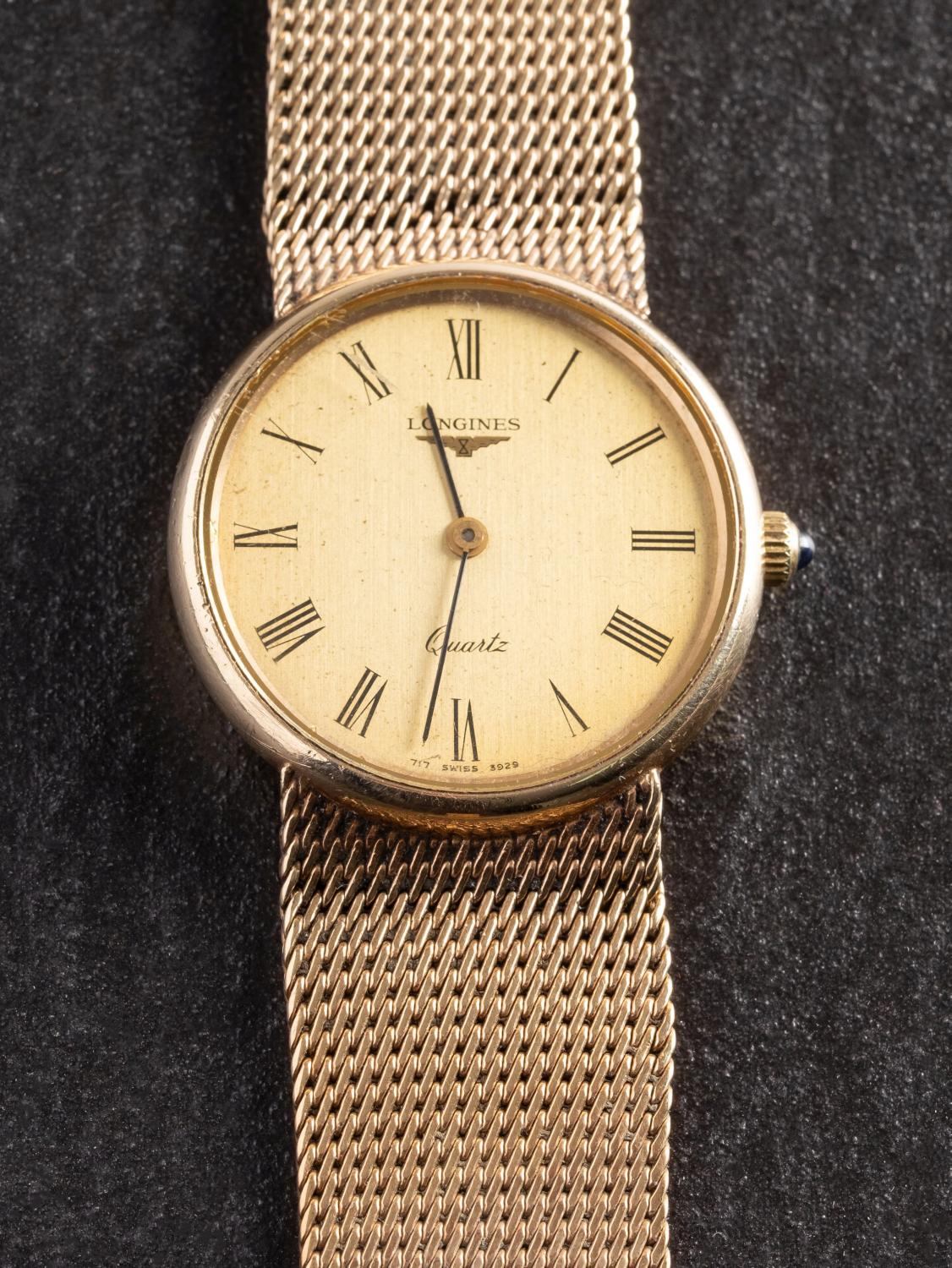 Longines, a gold gentlemans wristwatch the dial with black Roman numerals,