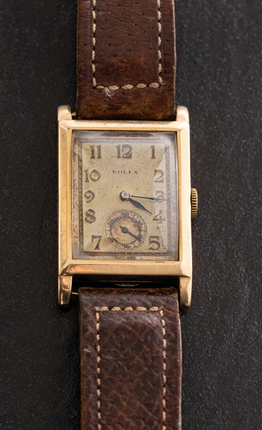 Rolex, a 1930s gentlemans gold rectangular wristwatch the dial having raised Arabic numerals,