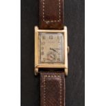 Rolex, a 1930s gentlemans gold rectangular wristwatch the dial having raised Arabic numerals,