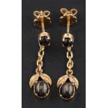 A pair of cabochon-cut star brown sapphire drop earrings of foliate design,