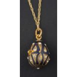 A black enamel and white paste, egg-shaped pendant, with control marks for Russia, Moscow,