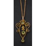 A cartouche-shaped, openwork, peridot pendant, together with a 9ct gold, bezel-link chain,