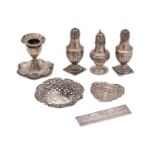 A mixed collection of silverwares, various makers and dates includes;- condiments, desk candlestick,