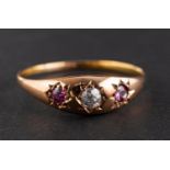 An old-cut diamond and probably garnet three-stone ring, estimated diamond weight ca. 0.