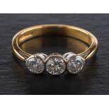 An 18ct gold, round, brilliant-cut, three-stone diamond ring, total estimated diamond weight ca. 0.