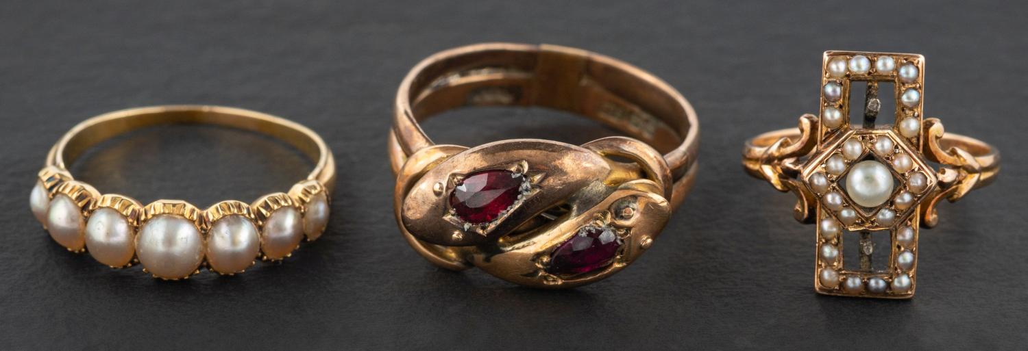 Three rings, including a 9ct gold, garnet double ouroboros ring, with hallmarks for Birmingham 1906,