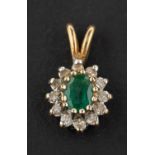 An oval, mixed-cut emerald and single-cut diamond cluster pendant, estimated emerald weight ca. 0.