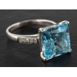 A step-cut blue topaz and diamond ring, estimated weight of topaz ca. 12.