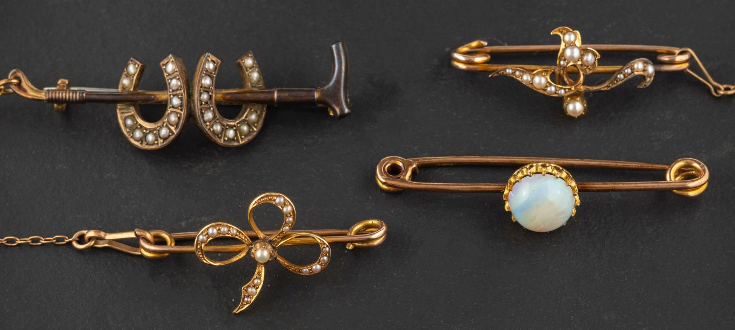 Four bar brooches, including a Victorian, 9ct gold riding crop and double horseshoe bar brooch,