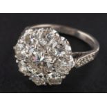 A round, brilliant-cut diamond cluster ring, estimated weight of principal diamond ca. 1.