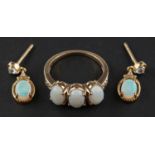 An oval cabochon-cut opal, three-stone ring, with white paste to shoulders, stamped 10K,