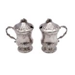 A pair of Continental silver lidded mustard pots, bears import marks for London,