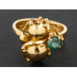 An 18ct gold, round, mixed-cut green tourmaline ring, in the form of a gourd entwined by tendrils,