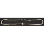 A graduated necklace of cultured pearls, the pearls of white hue with pink overtones,