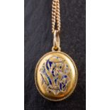 An oval, locket pendant, with blue enamel monogram 'TS',