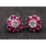 An 18ct gold pair of round, brilliant-cut diamond and ruby cluster ear studs,