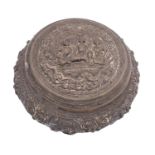 A Burmese silver jar and cover of circular form with repousse decoration of figures in interiors,