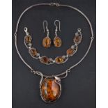 A oval amber necklace, bracelet and pair of earrings, with applied floral and foliate decoration,