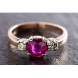 A ruby and round, brilliant-cut diamond three-stone ring, estimated ruby weight ca. 0.