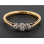 A single and round, brilliant-cut diamond, three-stone ring, total estimated diamond weight ca. 0.