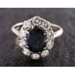An 18ct gold, mixed-cut oval sapphire and round, brilliant-cut diamond cluster ring,
