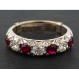 A ruby and round, brilliant-cut diamond half-eternity ring, total estimated diamond weight ca. 0.