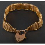 A gate-link bracelet with heart-shaped clasp, stamped '9CT', total length ca. 20.