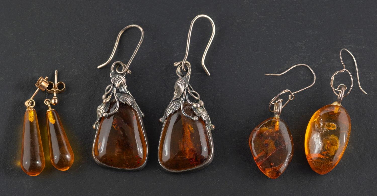 Three pairs of amber drop earrings,