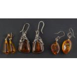 Three pairs of amber drop earrings,