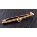 A round, brilliant-cut diamond bar brooch, estimated diamond weight ca. 0.