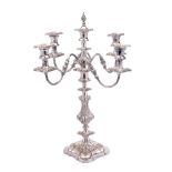 A 19th Century silver plated four-branch candelabrum with reeded scrolling arms terminating in