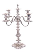 A 19th Century silver plated four-branch candelabrum with reeded scrolling arms terminating in